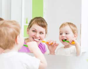 Mother and child practicing healthy dental care 