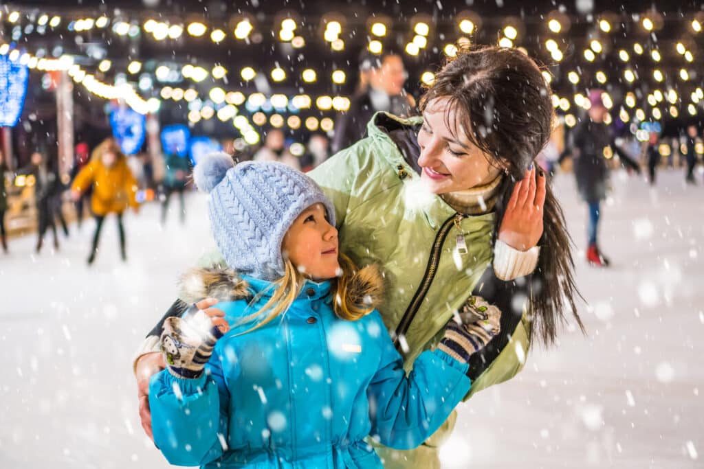 happy mom and child ice skating